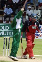 Tony Suji celebrates removing Terrence Duffin ... but Zimbabwe eventually won to level the series © AFP